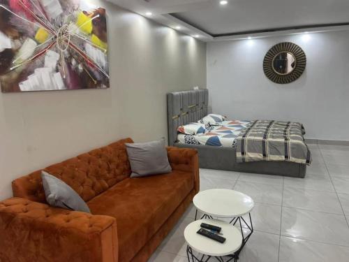 a living room with a couch and a bed at Immeuble cgk in Cocody