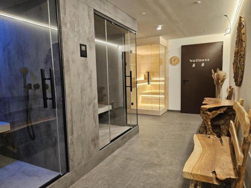 a bathroom with a walk in shower and a glass door at Residence Stella Alpina in Santa Cristina Gherdëina