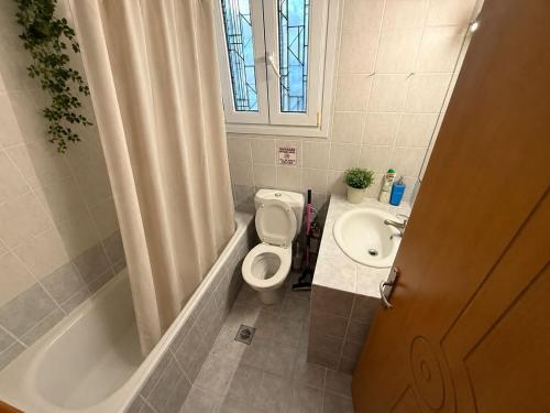 a bathroom with a toilet and a sink at Apartment Deniz in Nea Peramos