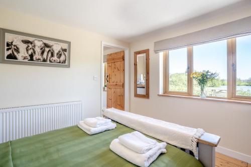 a room with a bed with two towels on it at 3 Bed in Bassaleg oc-bow138 in Bassaleg