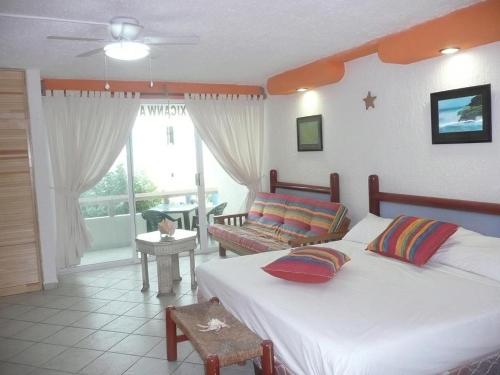 un dormitorio con 2 camas y un gato sentado en una mesa en Cancun Beach ApartHotel by Solymar, en Cancún