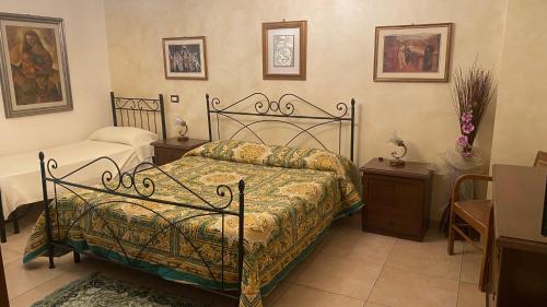a bedroom with a bed and two night stands and a table at Sole nascente in Furci Siculo