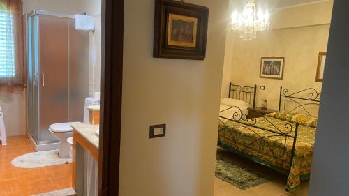 a room with a bedroom with a bed and a bathroom at Sole nascente in Furci Siculo