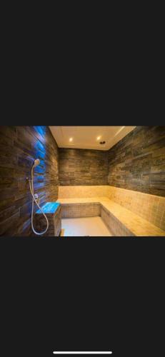 a bathroom with a bath tub with a shower at Apartament Atrium Sarbinowo in Sarbinowo