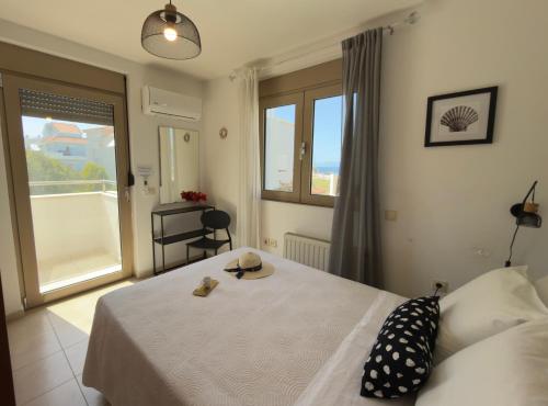 a bedroom with a bed and a large window at Marilena Mare Seaside & Jacuzzi House 50meters from sea in Ialysos