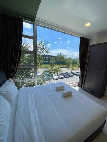 a bedroom with a large bed with a large window at Hotel Double Star Klia in Sepang