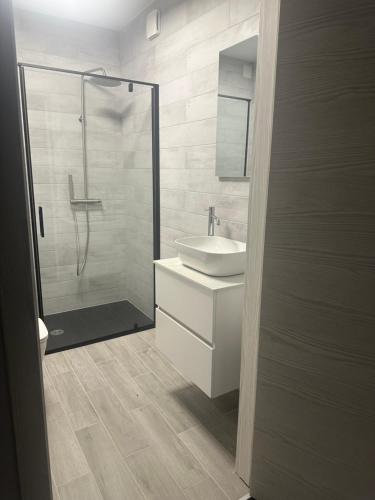 a bathroom with a sink and a shower at Hotel Kürschner in Kötschach