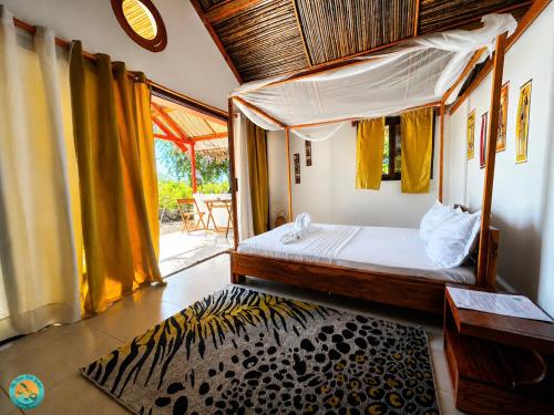 a bedroom with a bed in a room with a window at Ny Fano Kite Lodge in Ivovona