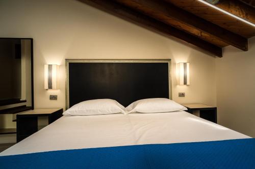 a bedroom with a large bed with two night stands at Viscuso House B&B in Aci Castello