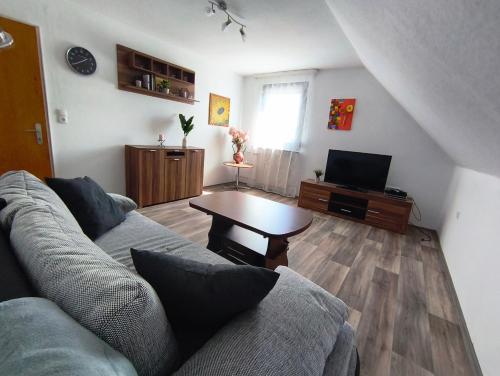 a living room with a couch and a table at FeWo Rina in Pottenstein