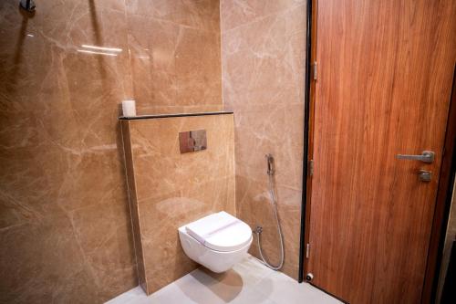 a bathroom with a toilet and a shower at Hotel Avenue 30 in Lucknow