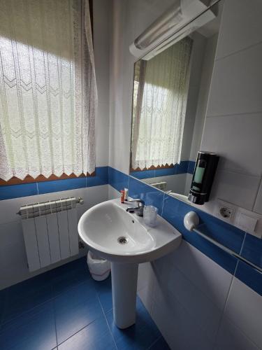 a bathroom with a white sink and a mirror at Hostal Restaurante Piedra in Limpias