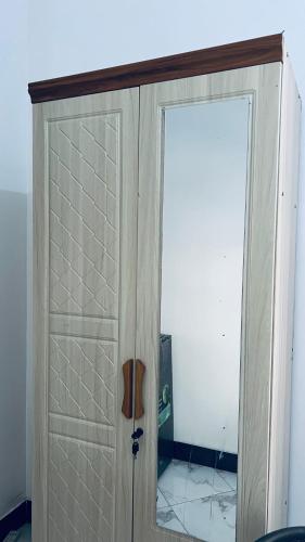 a white cabinet with a door in a room at Osim bnb 2 in Arusha