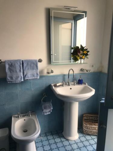 a bathroom with a sink and a toilet and a mirror at Azzurrina in Marettimo