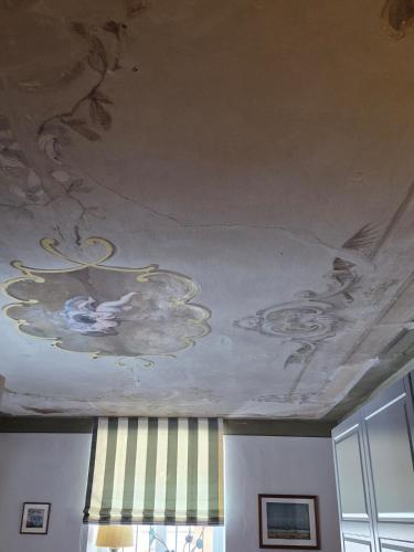 a ceiling with a painting of people on it at Entzückendes Studio in historischer Villa in Aschau