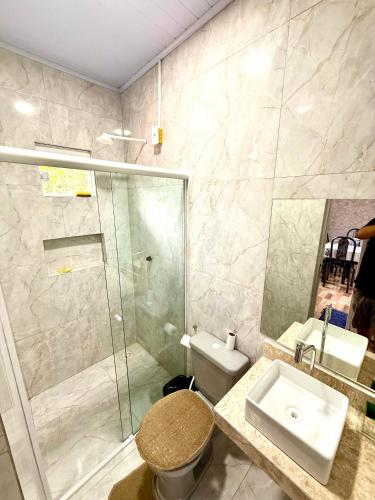a bathroom with a shower and a toilet and a sink at Lardunas in Santo Amaro
