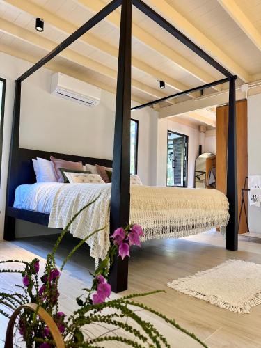 a bedroom with a canopy bed in a room at Bearwolf Koh Kood in Ko Kood