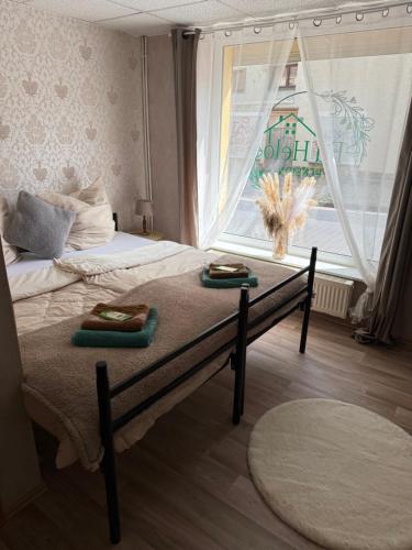 a bedroom with a bed with two towels on it at Pension EdHeLo in Barby