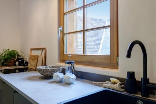 a kitchen counter with a sink and a window at Hofgut Heiligenberg in Heiligenberg
