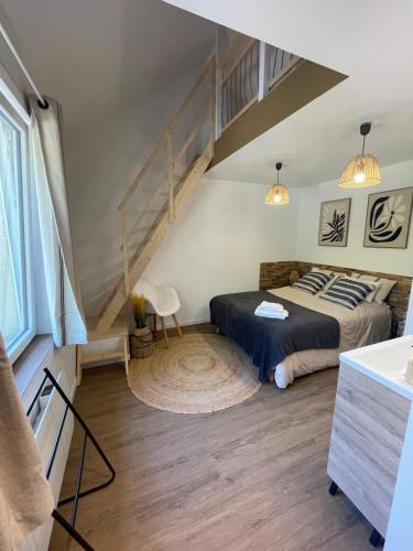 a bedroom with a bed and a staircase at House in forest proche GR and circuit in Saint-Mars-la-Brière