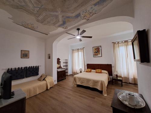 a bedroom with two beds and a ceiling at Azalea Guest House in Siena