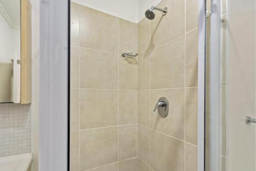 a shower with a glass door in a bathroom at Spacious Studio Fourways Sandton - Self Check-in in Sandton