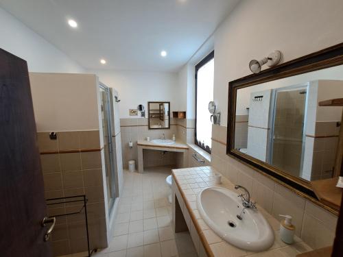 a bathroom with a sink and a mirror at Azalea Guest House in Siena