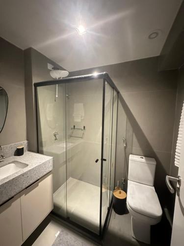 a bathroom with a shower and a toilet and a sink at View Soft House - Quarto e Sala 213 in Lauro de Freitas