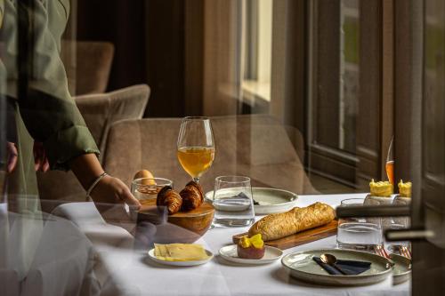 a table with a glass of wine and food on it at Karels Restaurant Hotel in Braamt