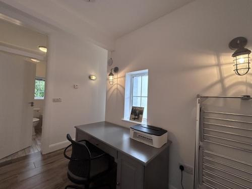 a room with a desk with a box on it at Guinness House in Ballyconneely