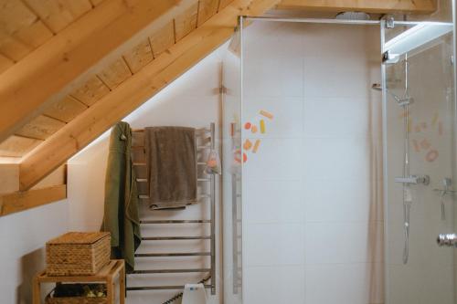 a bathroom with a shower and a stair case at Druhej Domek u ráje in Bystřice