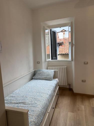a bed in a room with a window at Artdeco in Lecco