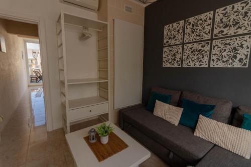 a living room with a couch and a table at Sea Steps 3 Marsalforn in Marsalforn