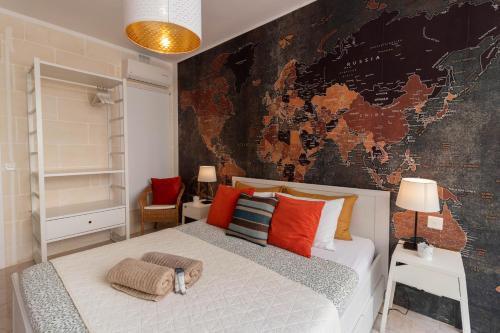 a bedroom with a bed with a map on the wall at Sea Steps 3 Marsalforn in Marsalforn