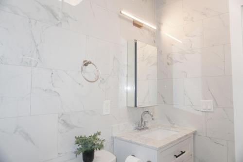 a white bathroom with a sink and a toilet at New York view 39 in West New York