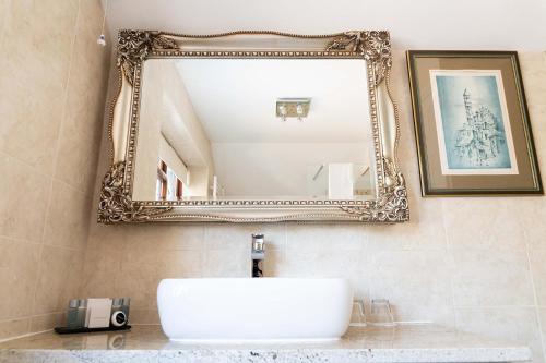 a bathroom with a sink and a mirror on the wall at The Stanwick Hotel in Stanwick