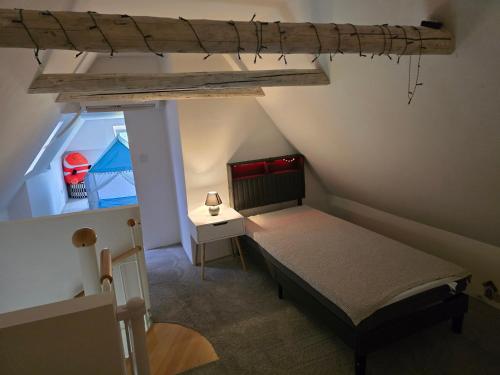 a small attic bedroom with a bed and a window at Naturparadies an der Saale in Könnern