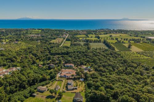 an aerial view of a house with trees and the ocean at Villa Santa Mara Poggio in Santa-Maria-Poggio
