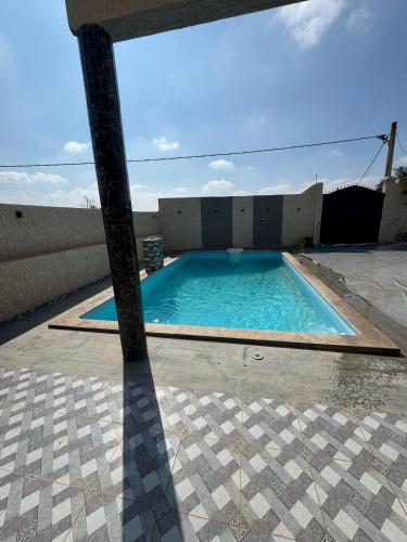 a large swimming pool on a patio at villa agadir in Glalcha