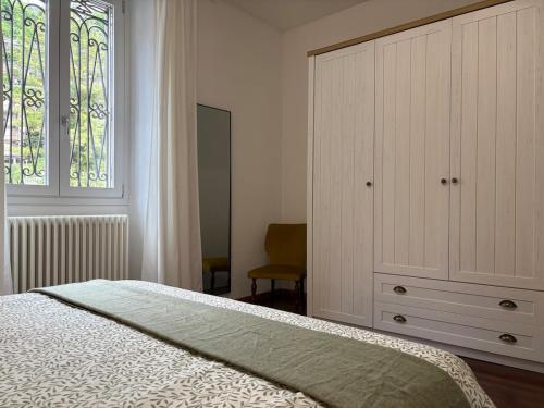 a bedroom with a bed and a dresser and a window at Lake Como - Casa Mafy in Bellano
