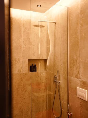 a shower with a glass door with a shower at Foga Aus in Ksamil