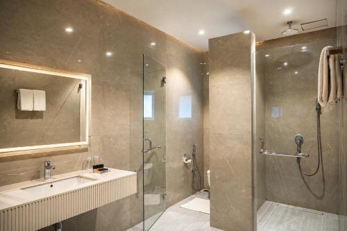 a bathroom with a shower and a sink at Central Residence by Paramount Hospitality in Karachi
