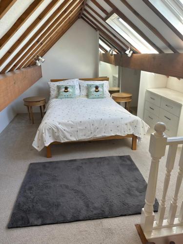 a bedroom with a bed in a attic at Boatman's Cottage in Rhoscolyn