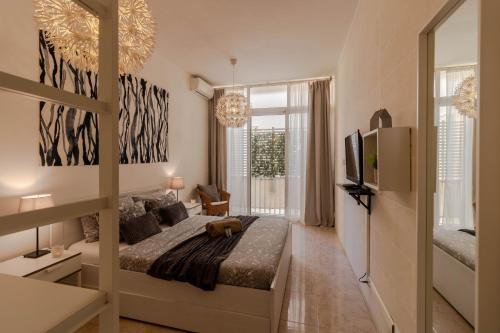 a bedroom with a bed and a large window at Sea Steps Marsalforn in Marsalforn