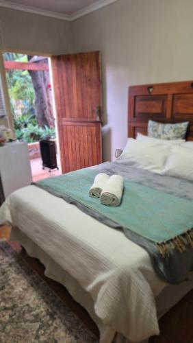 a bedroom with a large bed with towels on it at Herberg 1 in De Wildt