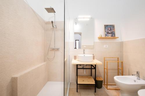 a bathroom with a shower and a sink and a toilet at L'Angolo Del Teatro in Galatone