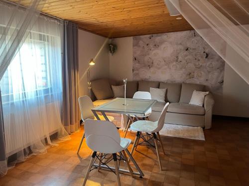 a living room with a table and a couch at Sandby in Karlholmsbruk