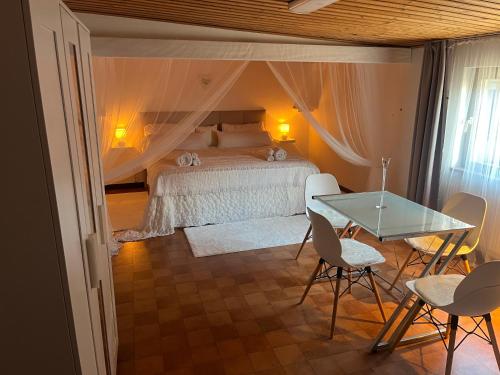 a bedroom with a bed and a table and chairs at Sandby in Karlholmsbruk