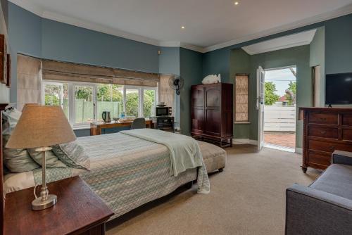 a bedroom with a bed and a desk and a chair at Mill Park Executive Suite in Hallack Rock
