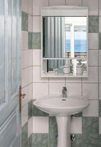 a bathroom with a sink and a mirror at Doma by Kristina in Chrysi Ammoudia